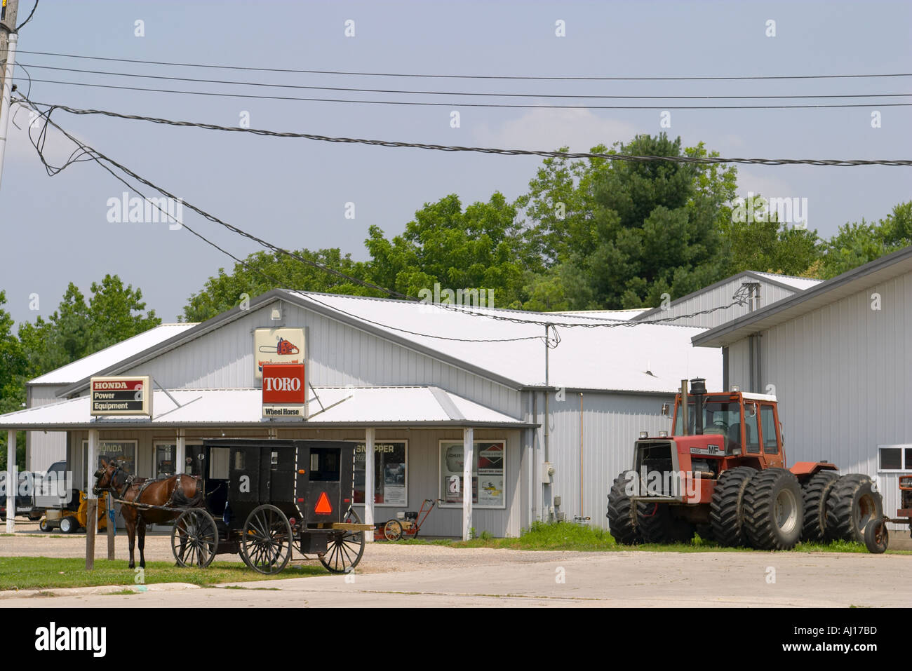 ILLINOIS Arthur Amish horse and buggy hitched outside farm equipment ...