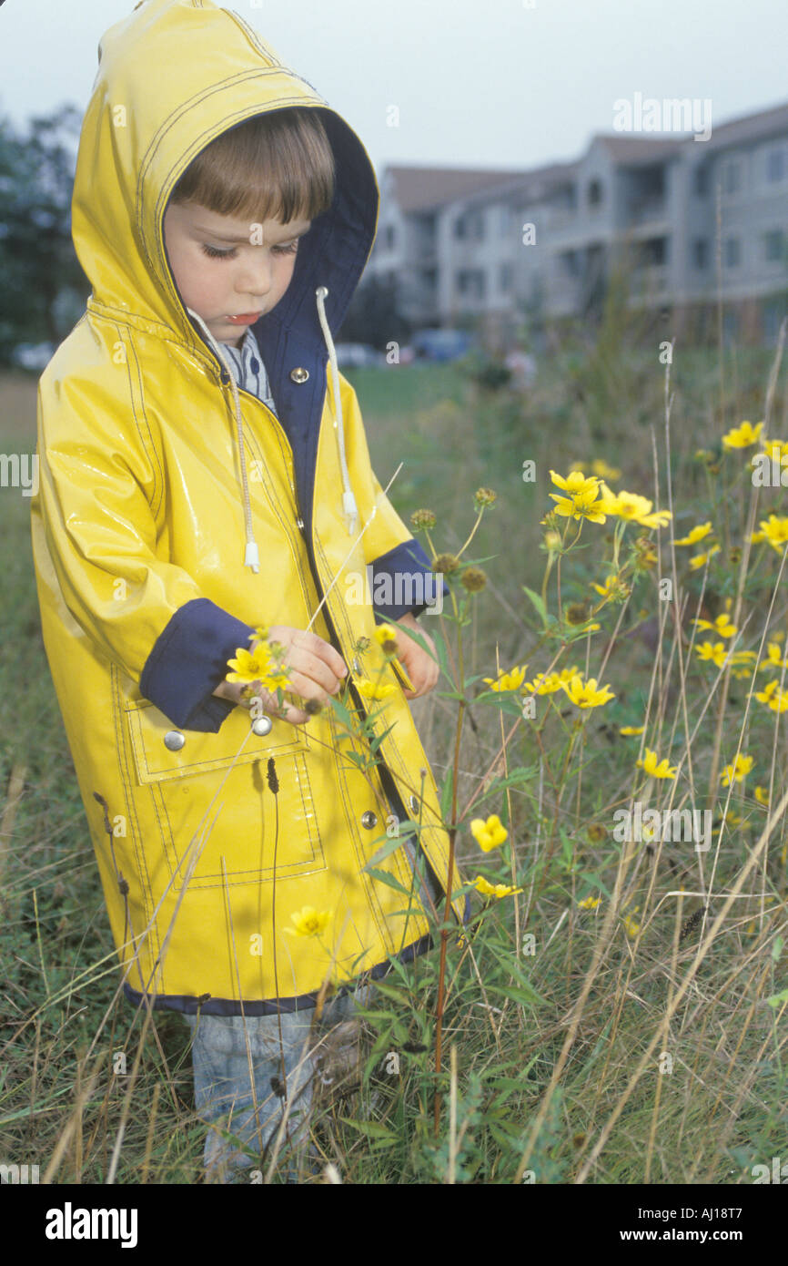 A boy exploring the wildflowers on a rainy day Washington D C Stock Photo