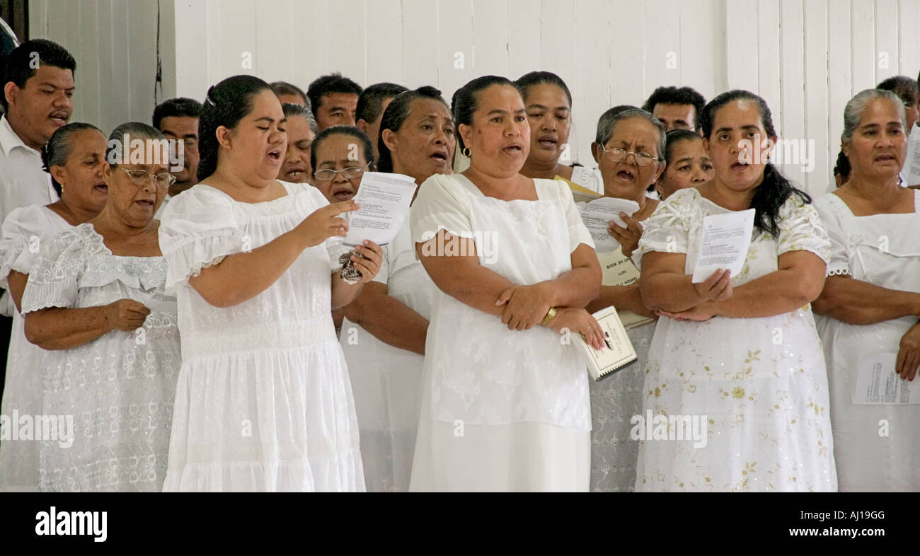 Micronesian women dressed in white lace and village men sing four part choral harmony during church service in Lelu in Kosrae Stock Photo