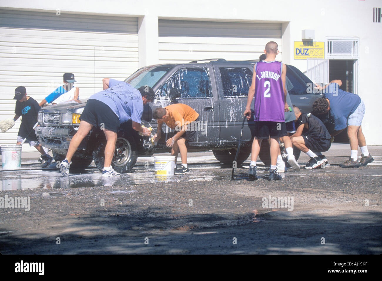 Students washing cars for a school fundraiser NM Stock Photo Alamy