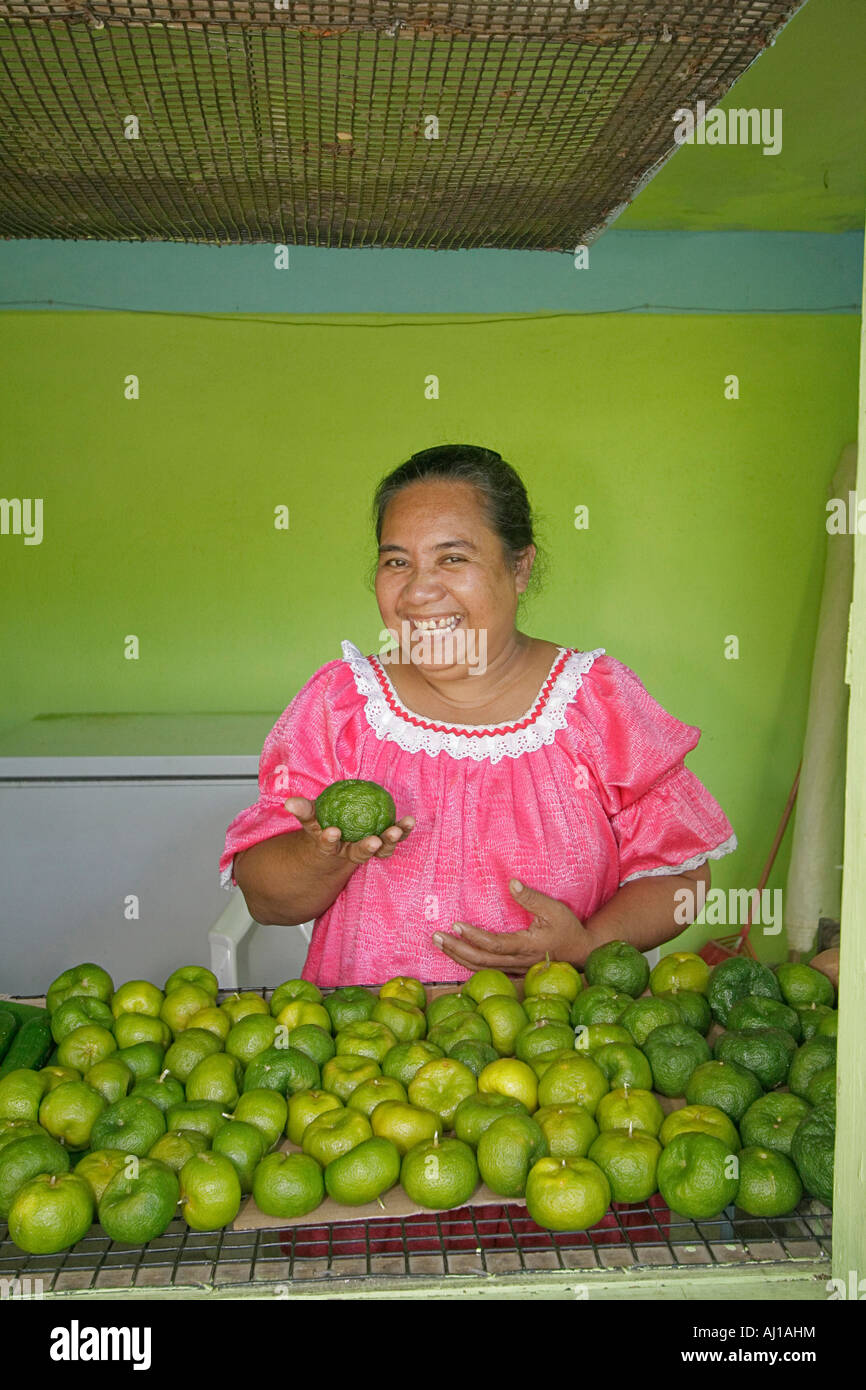 Kosrae woman displays tangerines she has for sale at her fruit stand in Kosrae Micronesia Stock Photo