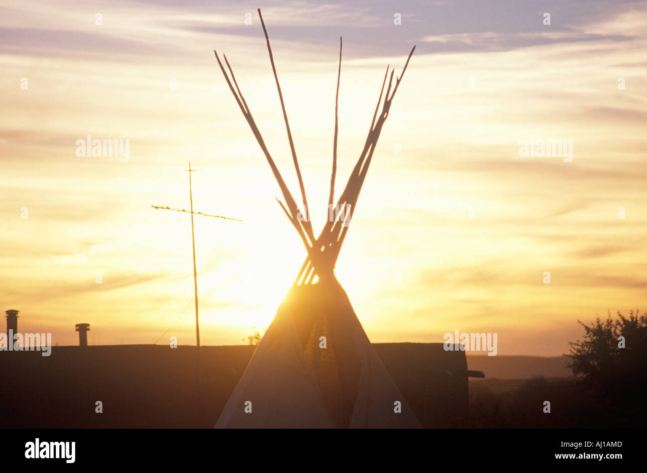 Teepee and cross silhouette on Indian reservation Stock Photo