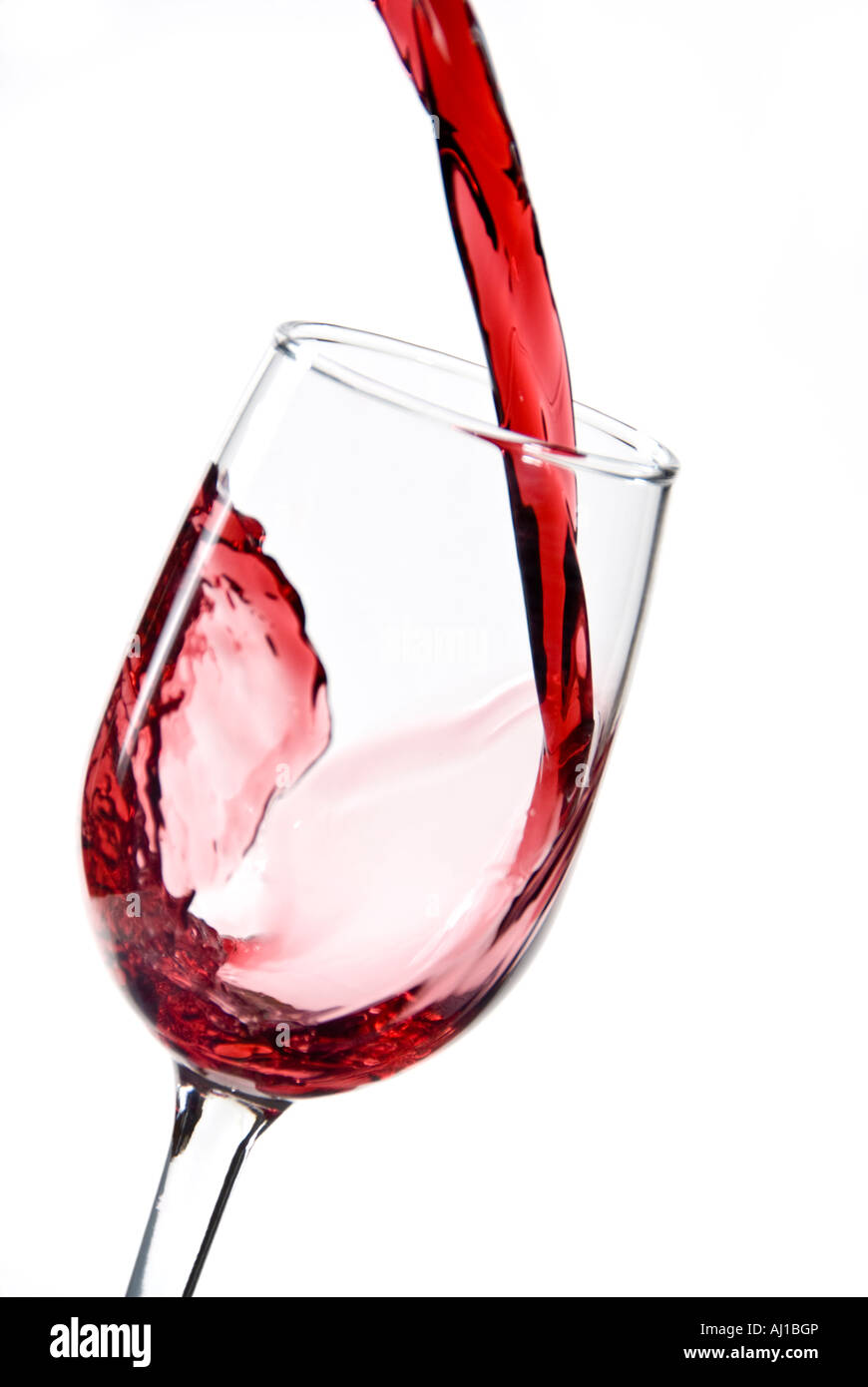 Pouring a glass of red wine into a wine glass Stock Photo