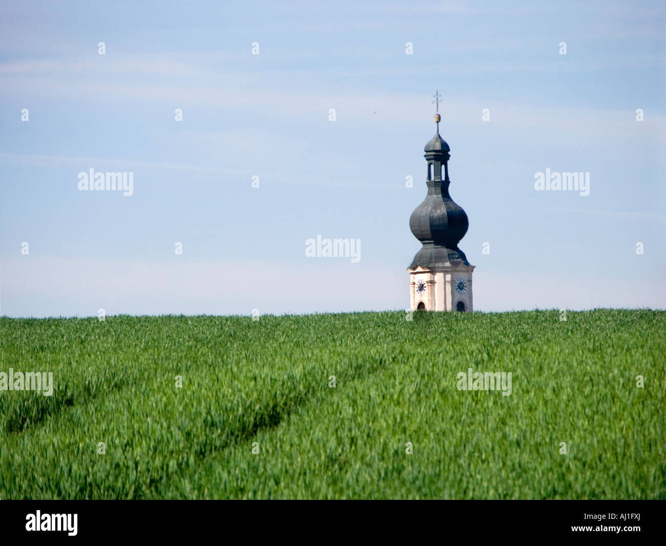 typical typically Bavaria Bavarian LOW BAVARIAN LANDSCAPE GERMANY field fields hill hills church tower steeple spire sky clouds Stock Photo