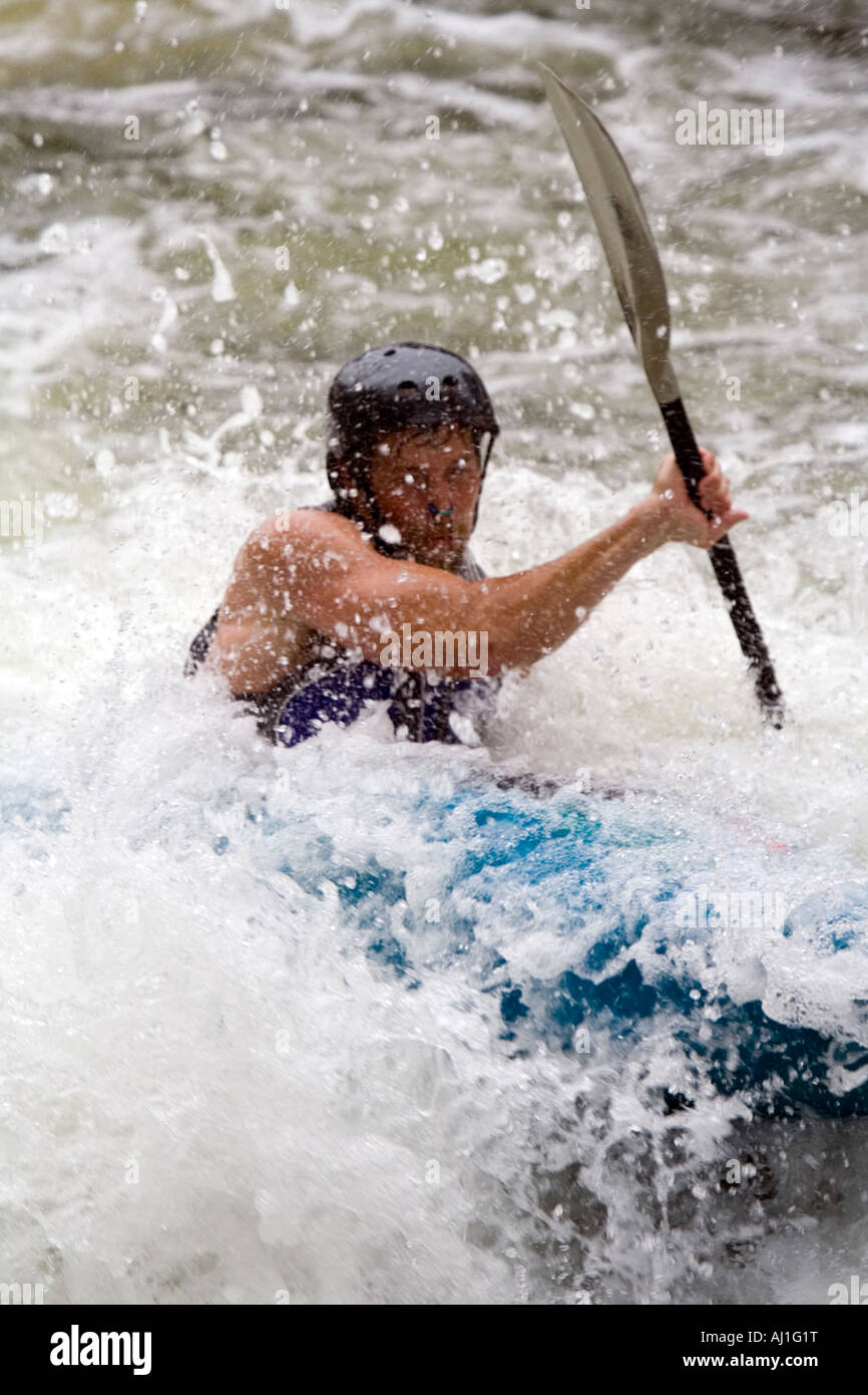 Paddling through whitewater current Stock Photo