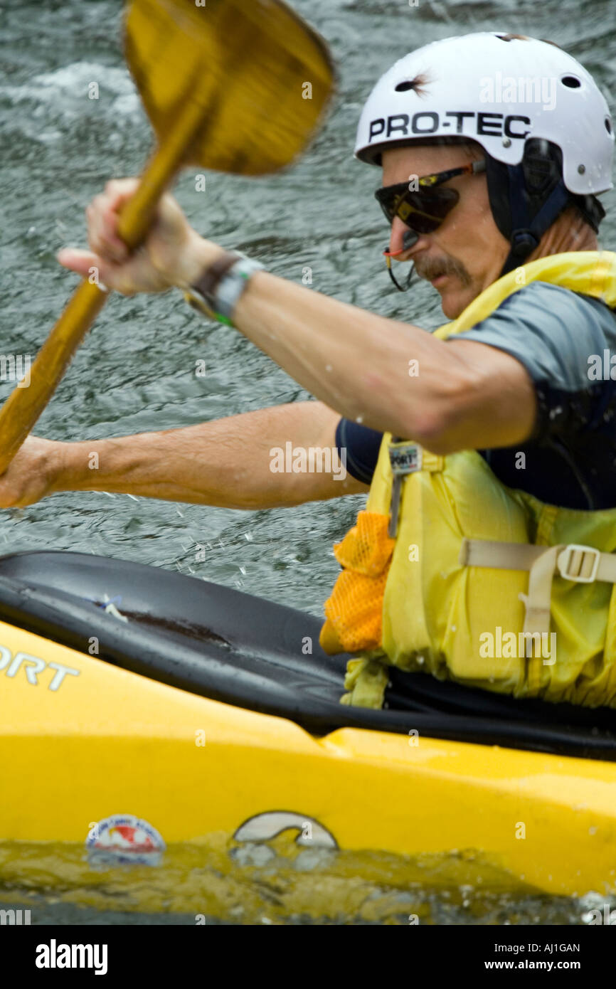 Paddling through whitewater current Stock Photo