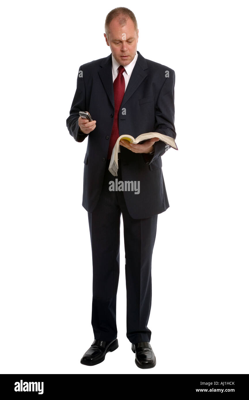 Businessman dialling a number from the phone book Stock Photo