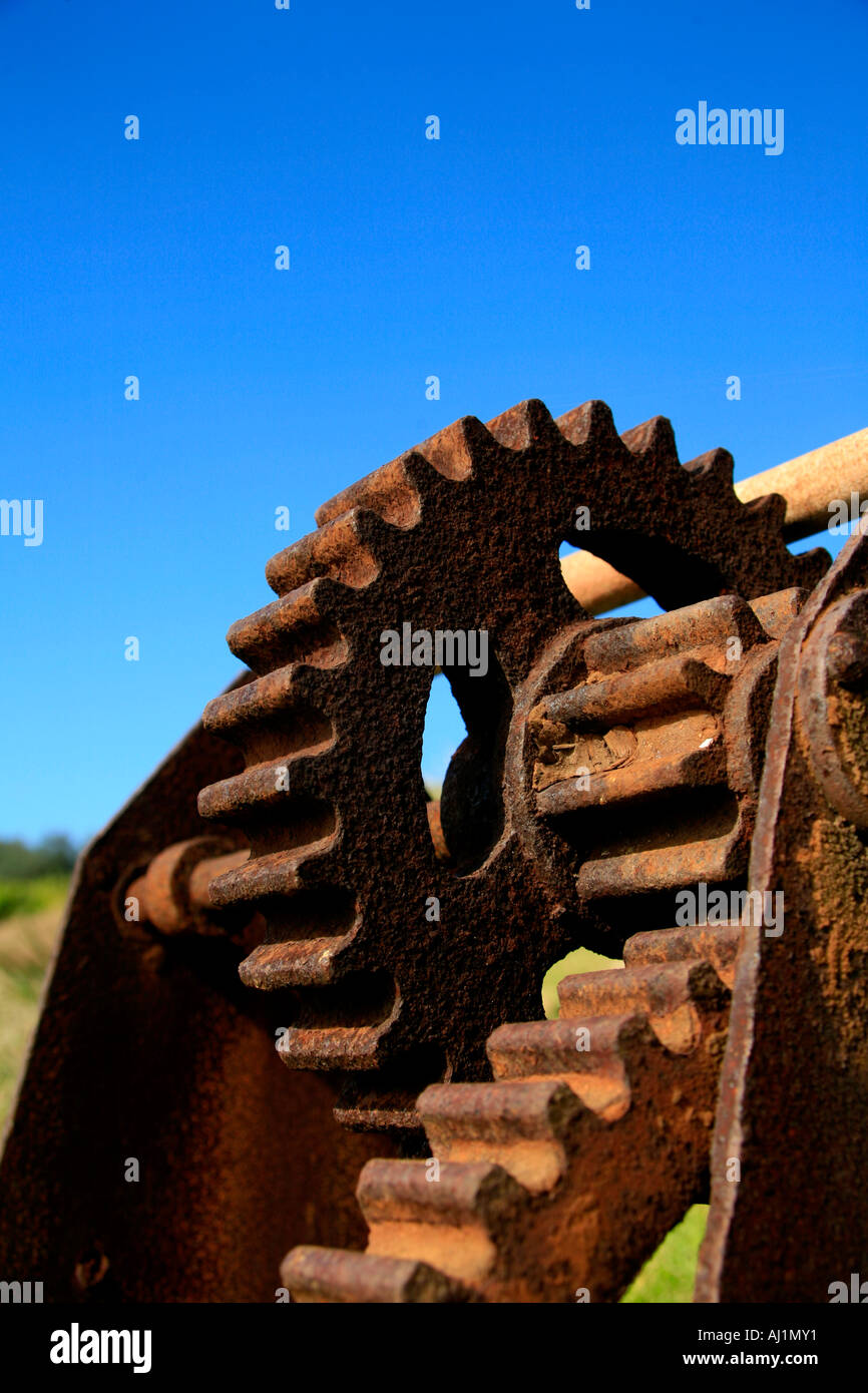 Rusted cogs against a blue sky Stock Photo