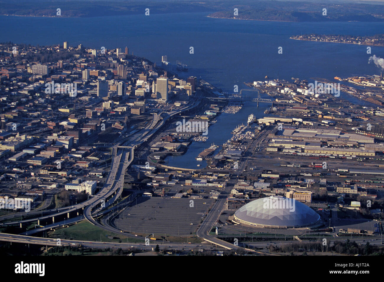 Aerial View Of Downtown Tacoma Washington With Tacoma Dome Arena In Foreground And Commencement Bay In Back Stock Photo