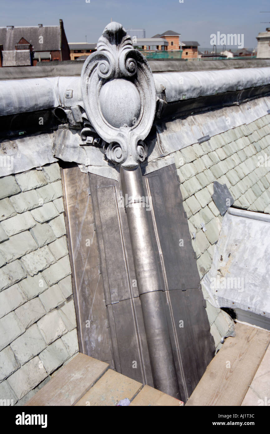 Roof refurbishment showing traditional lead skills with a rolled hip having been refurbished with new lead Stock Photo