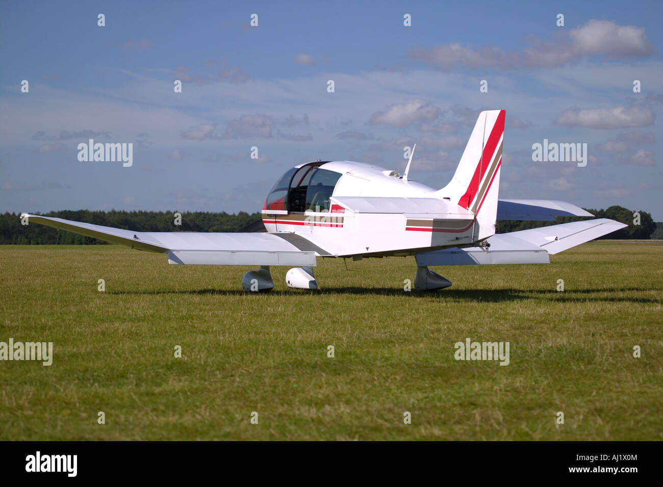 White light aircraft on a grass runway Stock Photo