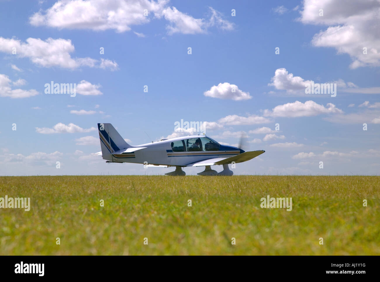 Light aircraft on a grass runway about to take off Stock Photo