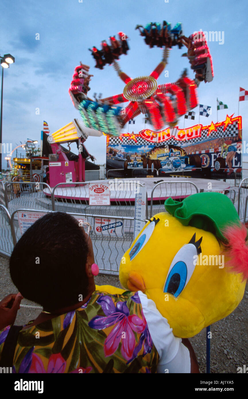 Ohio Franklin County,Columbus,Ohio State Fair carnival midway visitor holds prize Spin Out thrill ride,OH151 Stock Photo