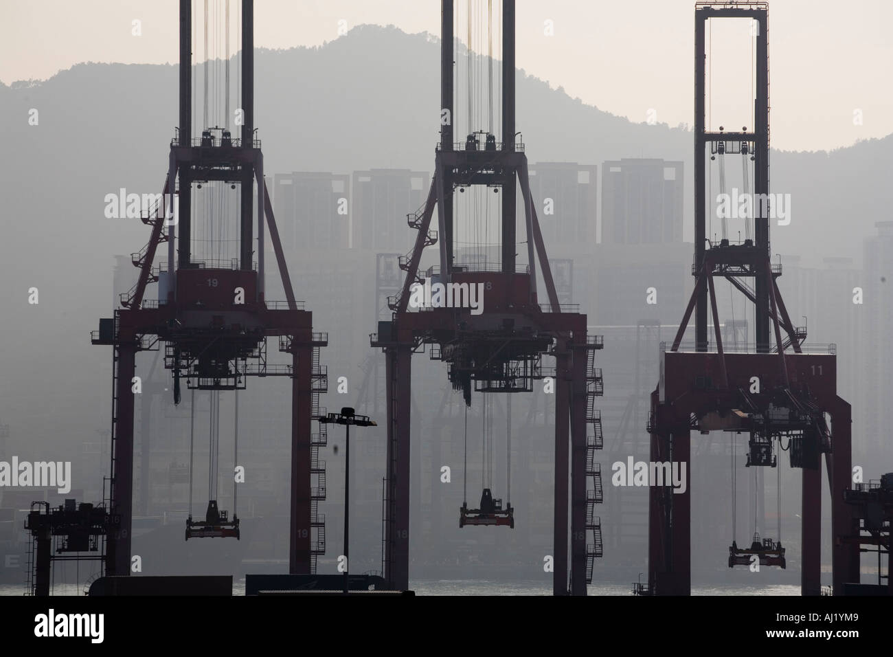 Asia Peoples Republic of China Hong Kong Silhouette of cargo cranes at ...