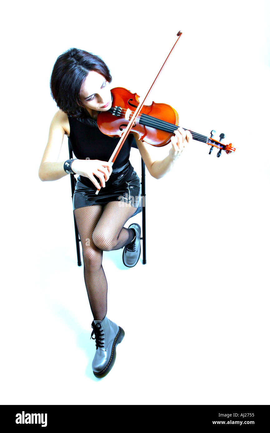 Young woman with heavy rock or punk appearance playing the violin Stock Photo