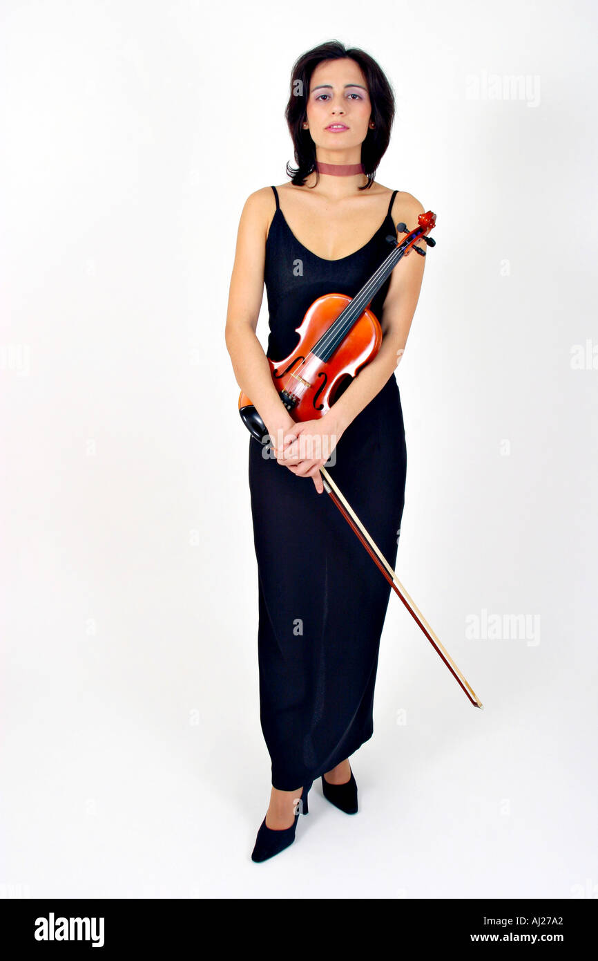 Full shot of young woman in black evening gown holding a violin Stock Photo