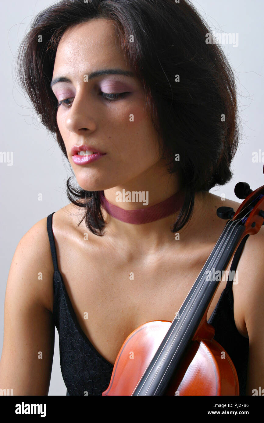 Headshot of young woman in black evening gown holding a violin Stock Photo