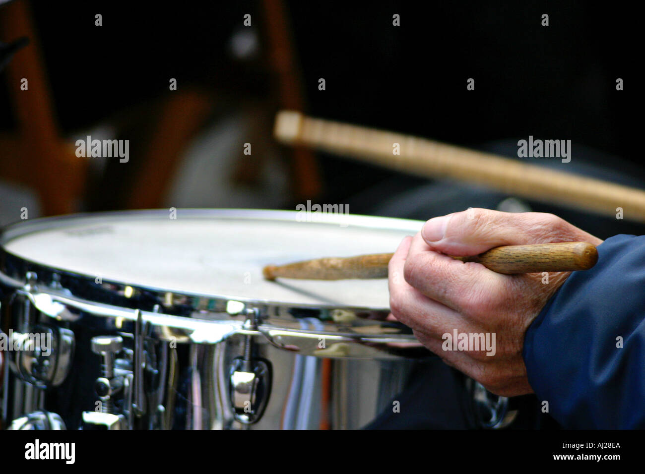 Hands with drumsticks playing a drum in a band Stock Photo Alamy