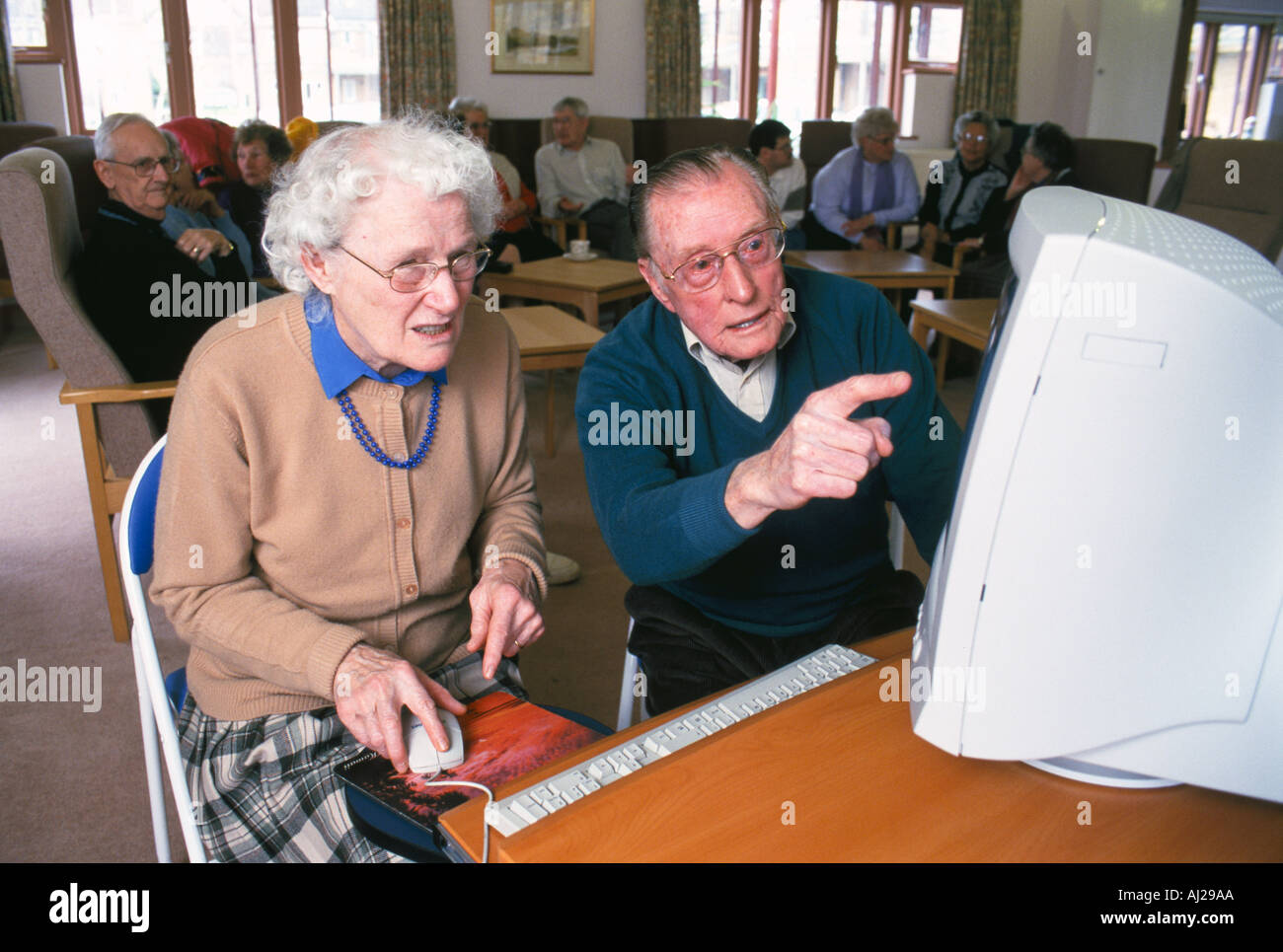 Group of elderly people using a computer Stock Photo - Alamy