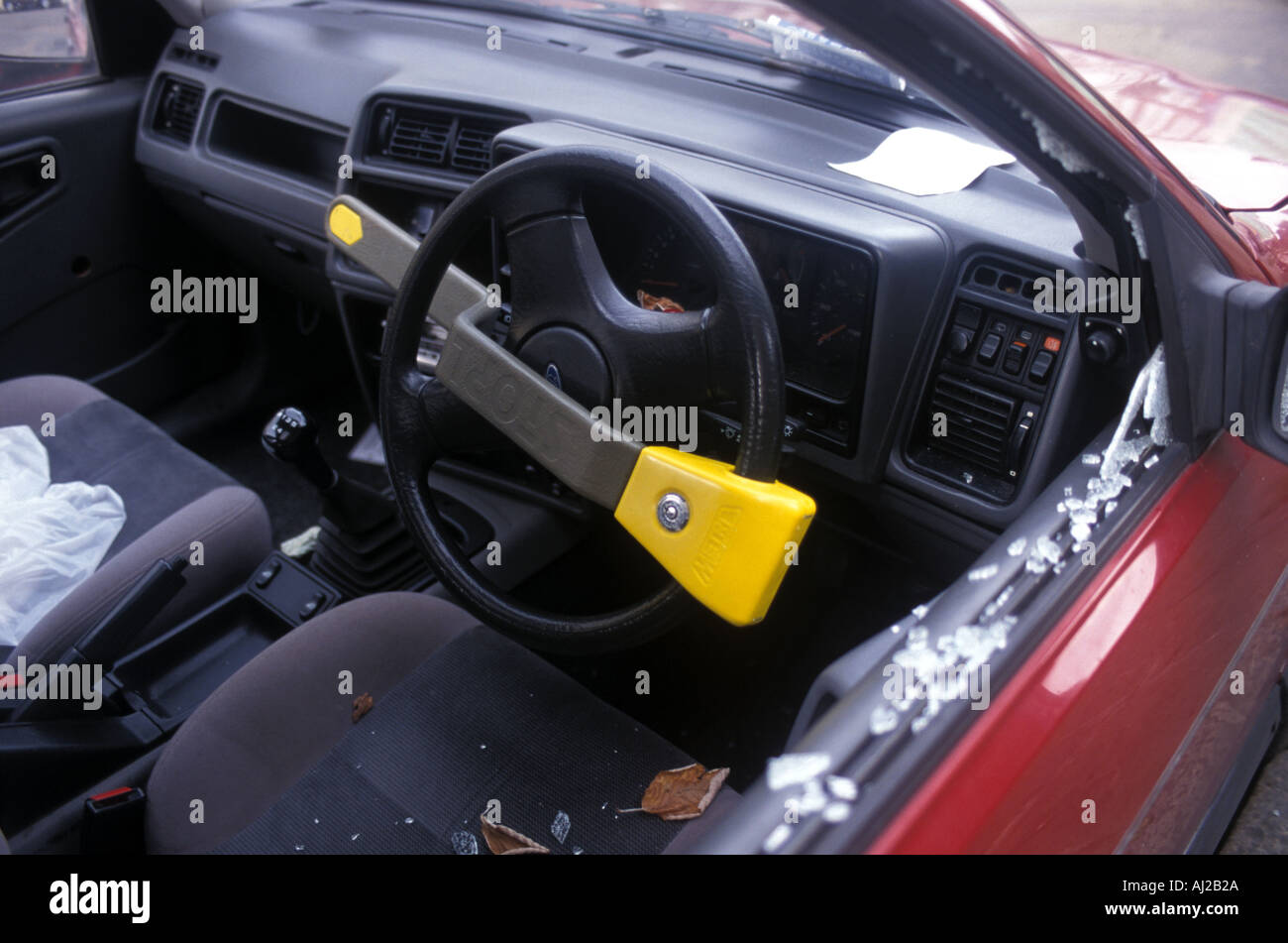 Car with steering wheel lock has broken window, England, UK Stock Photo