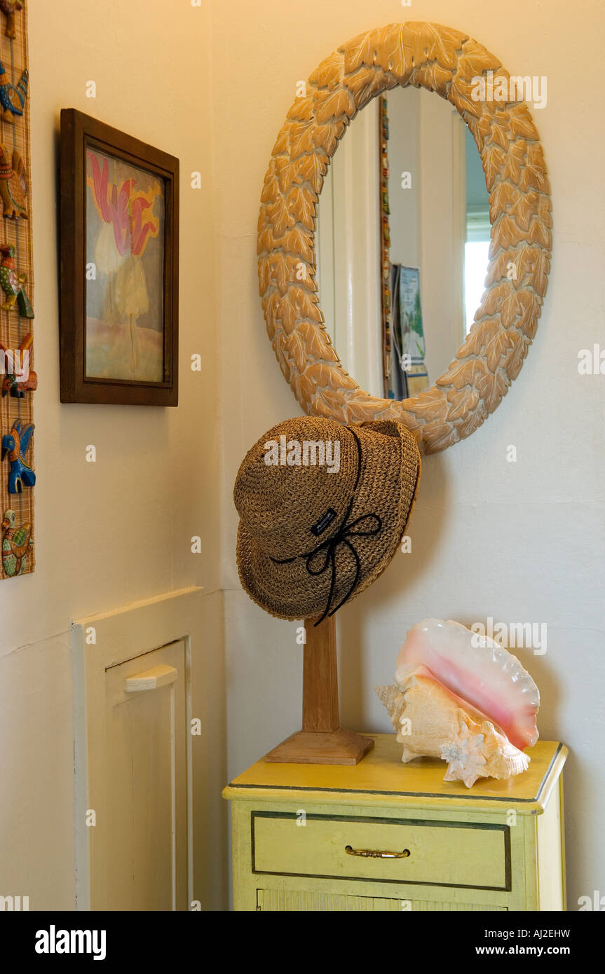 Conch Shells A Straw Sun Hat And A Wooden Mirror Decorate A