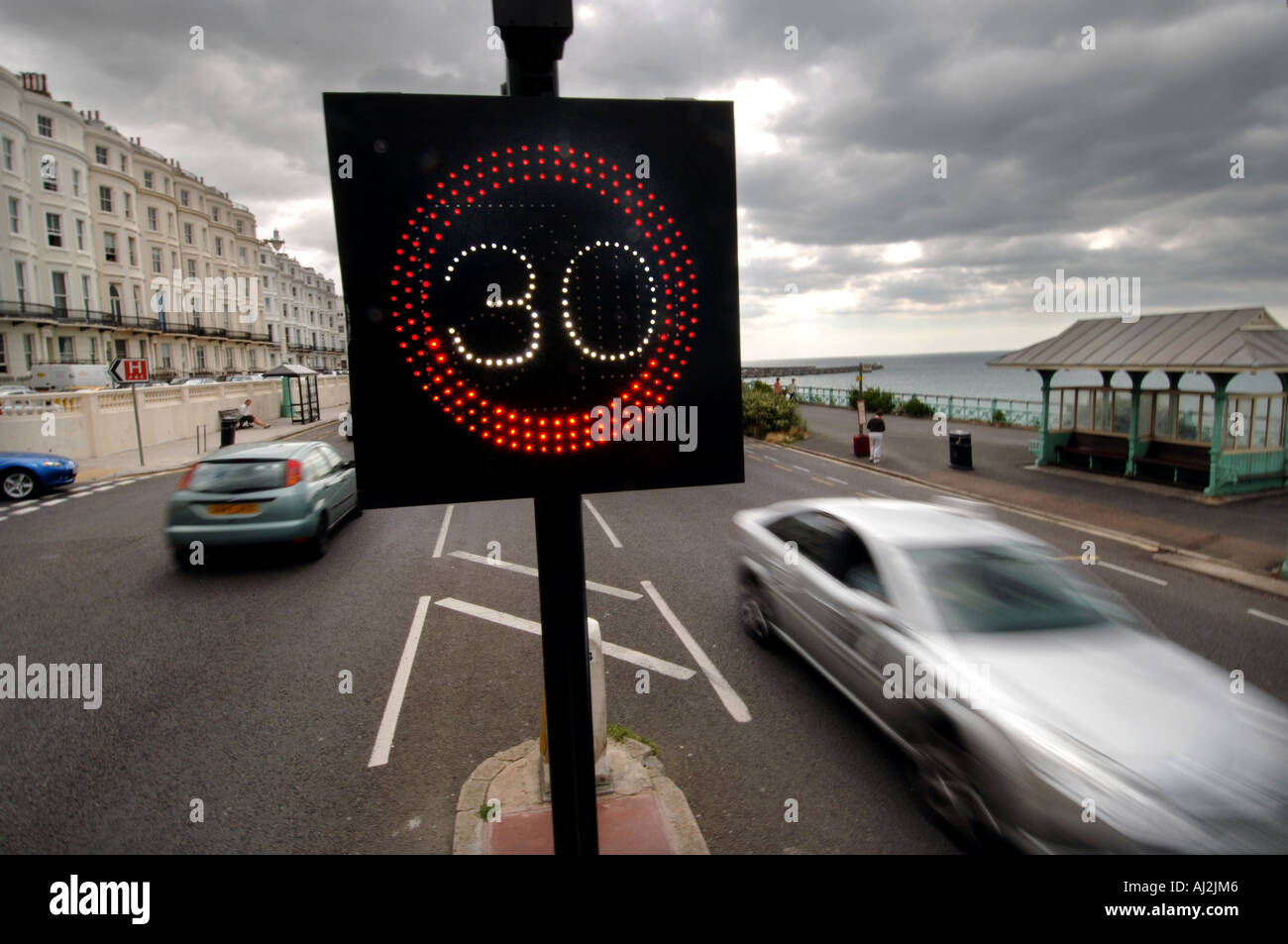 Traffic on Brighton seafront is warned of the 30 mph miles per hour speed limit by an illuminated sign Stock Photo
