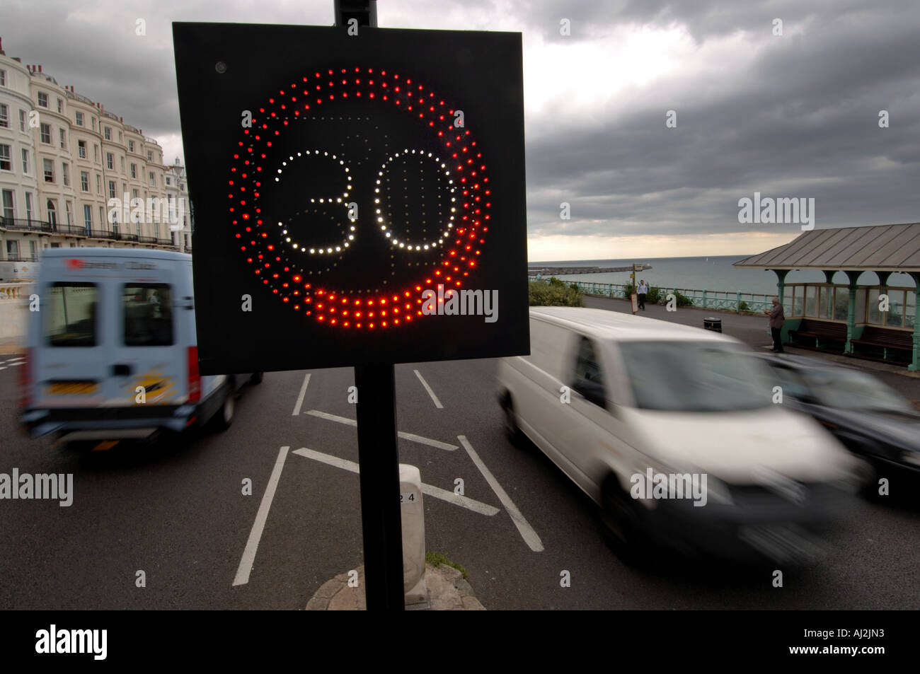 Traffic on Brighton seafront is warned of the 30 mph miles per hour speed limit by an illuminated sign Stock Photo