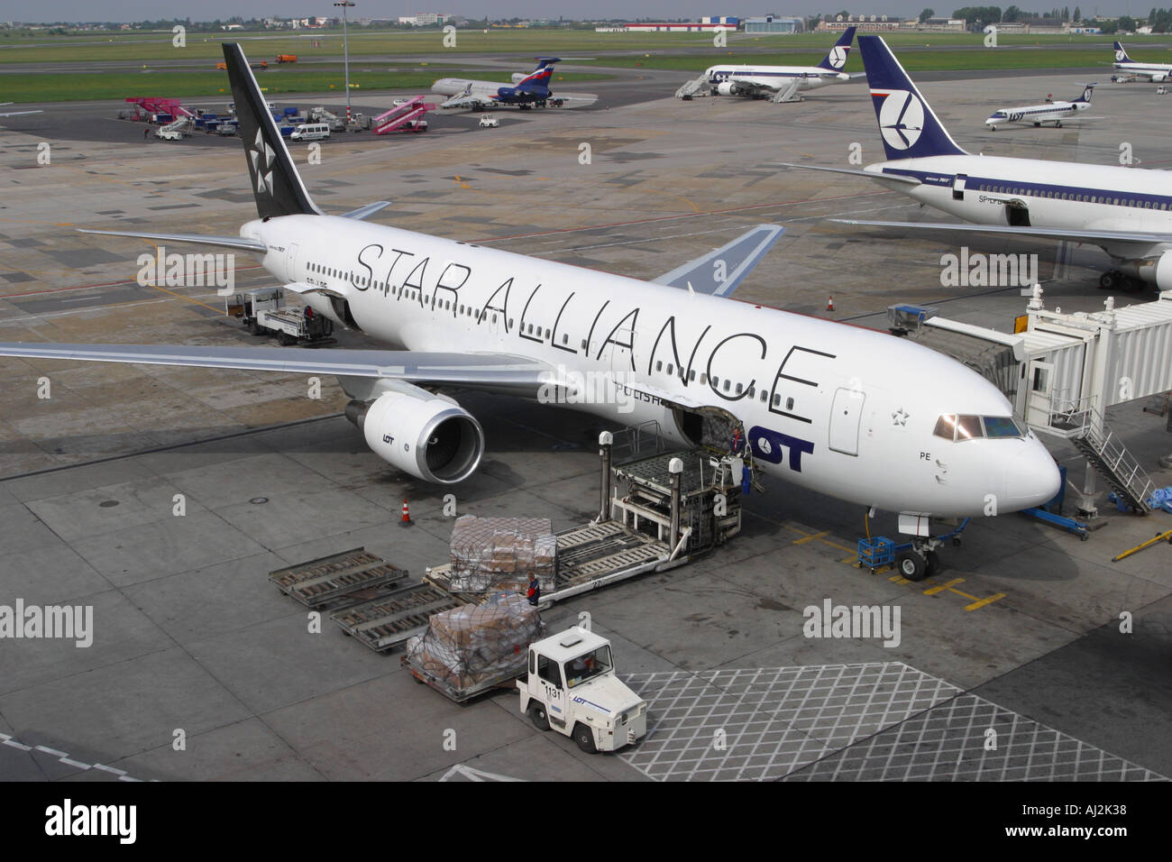 Star Alliance Boeing 767 operated by LOT Polish Airlines at Warsaw busy airport apron scene Poland Stock Photo