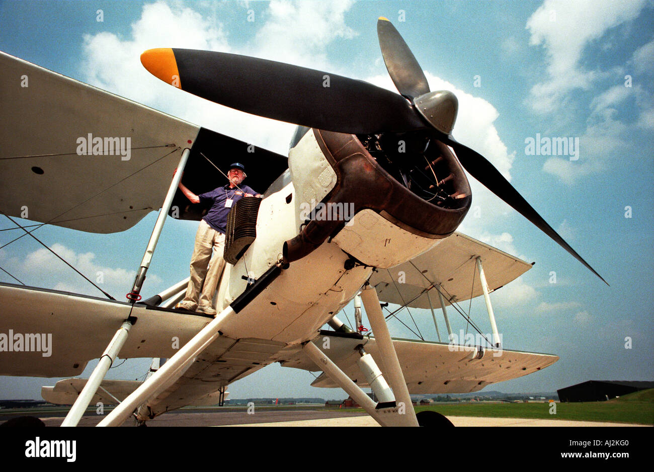 Former pilot John Tupper stands on the wing of his Swordfish bi-plane. Stock Photo