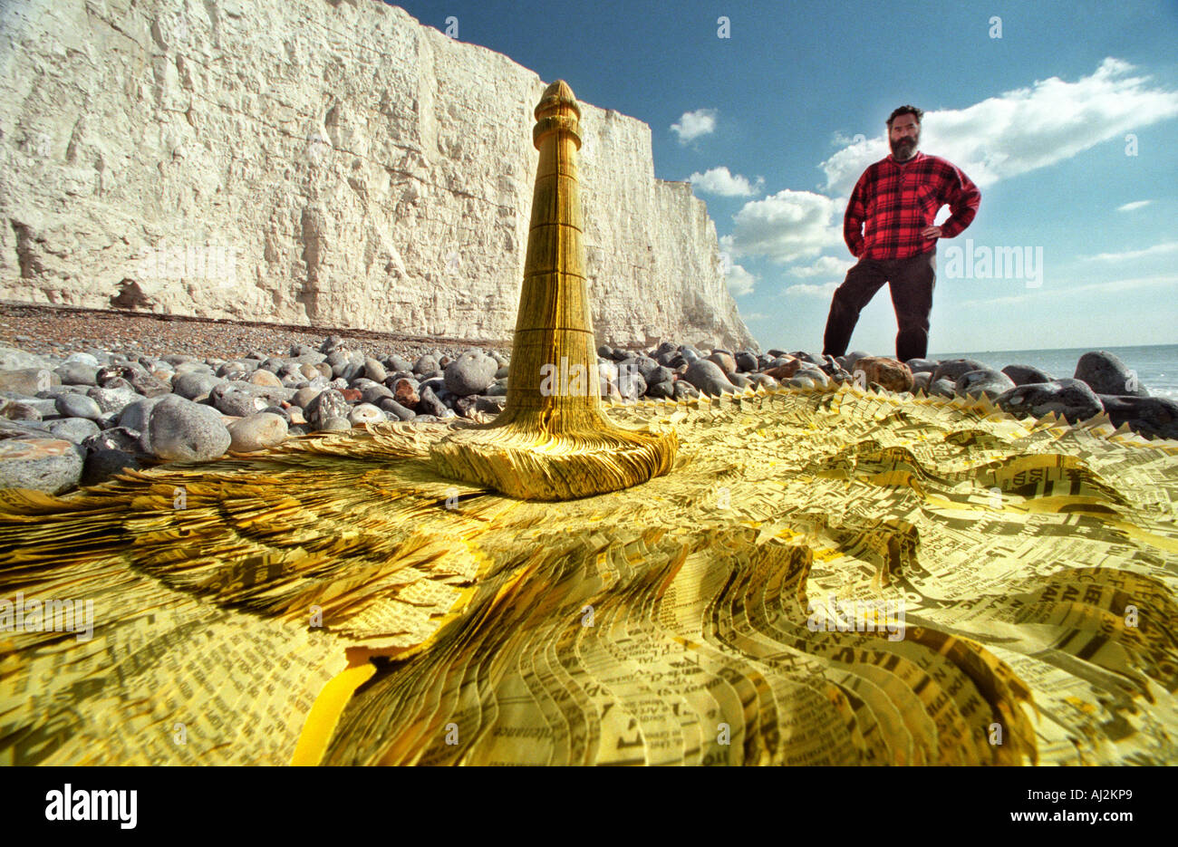 Sculptor Hamish Black with his sculpture of Beachy Head lighthouse fashioned out of recycled Yellow Pages telephone books Stock Photo