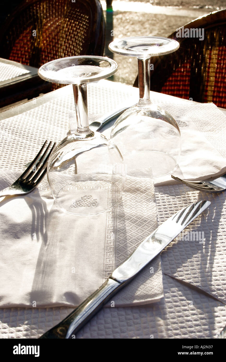 Paris France Al fresco brasserie restaurant Sun reflection and white napkins Stock Photo