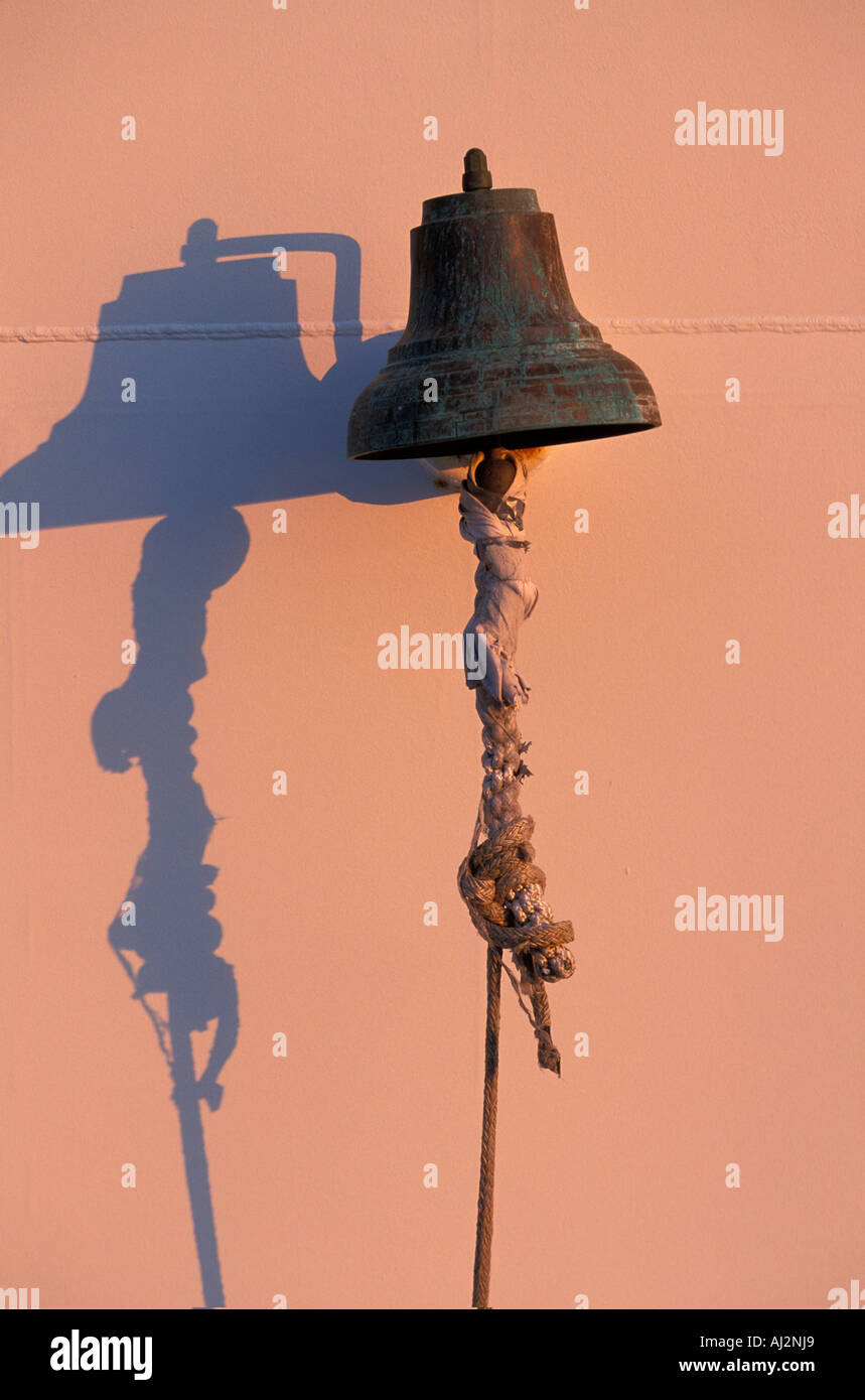 USA Washington Setting sun lights ship s bell on deck of U of Washington research ship R V Thomas G Thompson Stock Photo