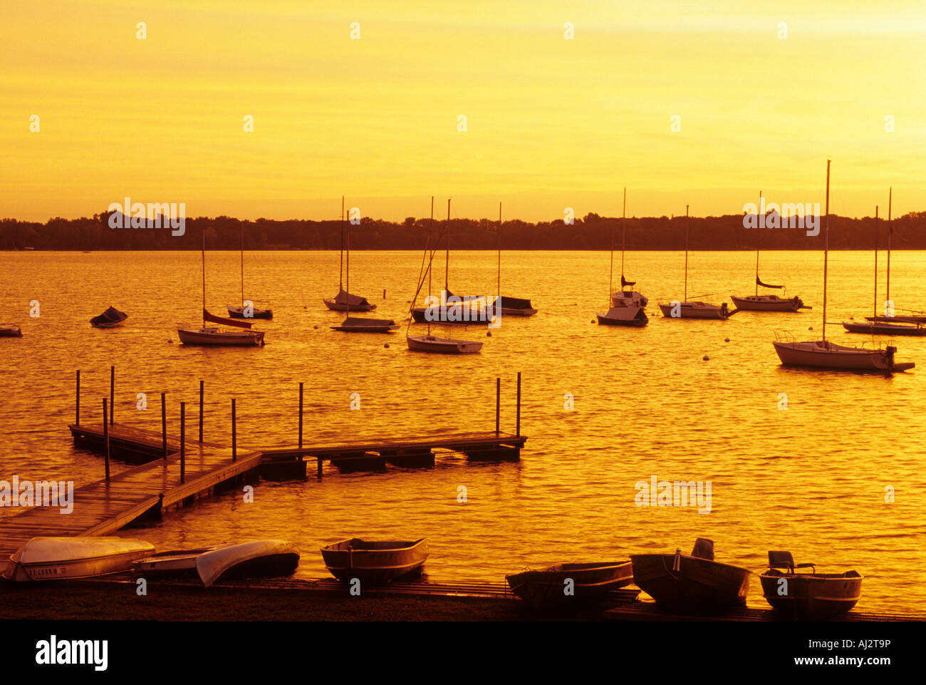BOATS AND DOCK ON WHITE BEAR LAKE, MINNESOTA, JUST NORTH OF ST. PAUL.  GOLDEN LIGHT AT END OF DAY.  SUMMER. AMERICA. Stock Photo