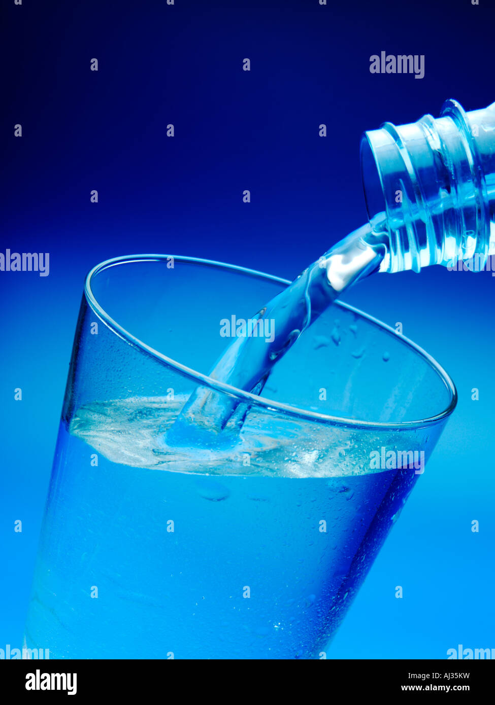A bottle pouring mineral water into a glass Stock Photo Alamy