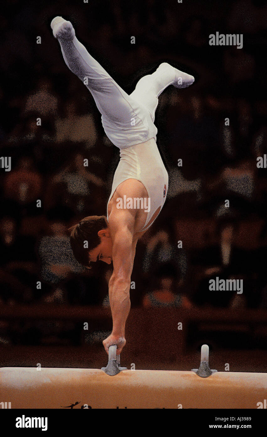 Russian male gymnast in a balanced position whilst competing on the