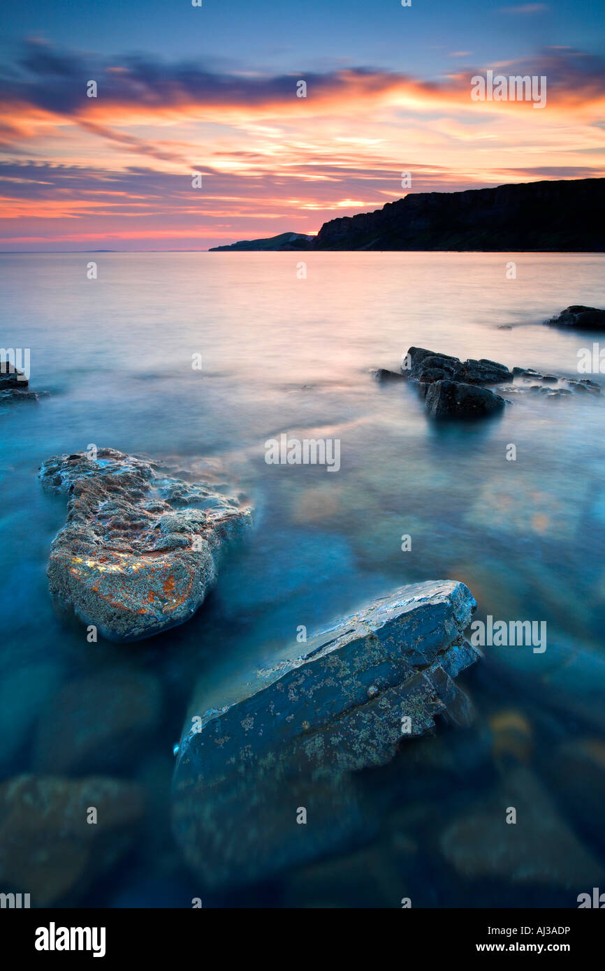 Sunset over Gad Cliff towering over Hobarrow and Brandy Bay, Dorset Stock Photo