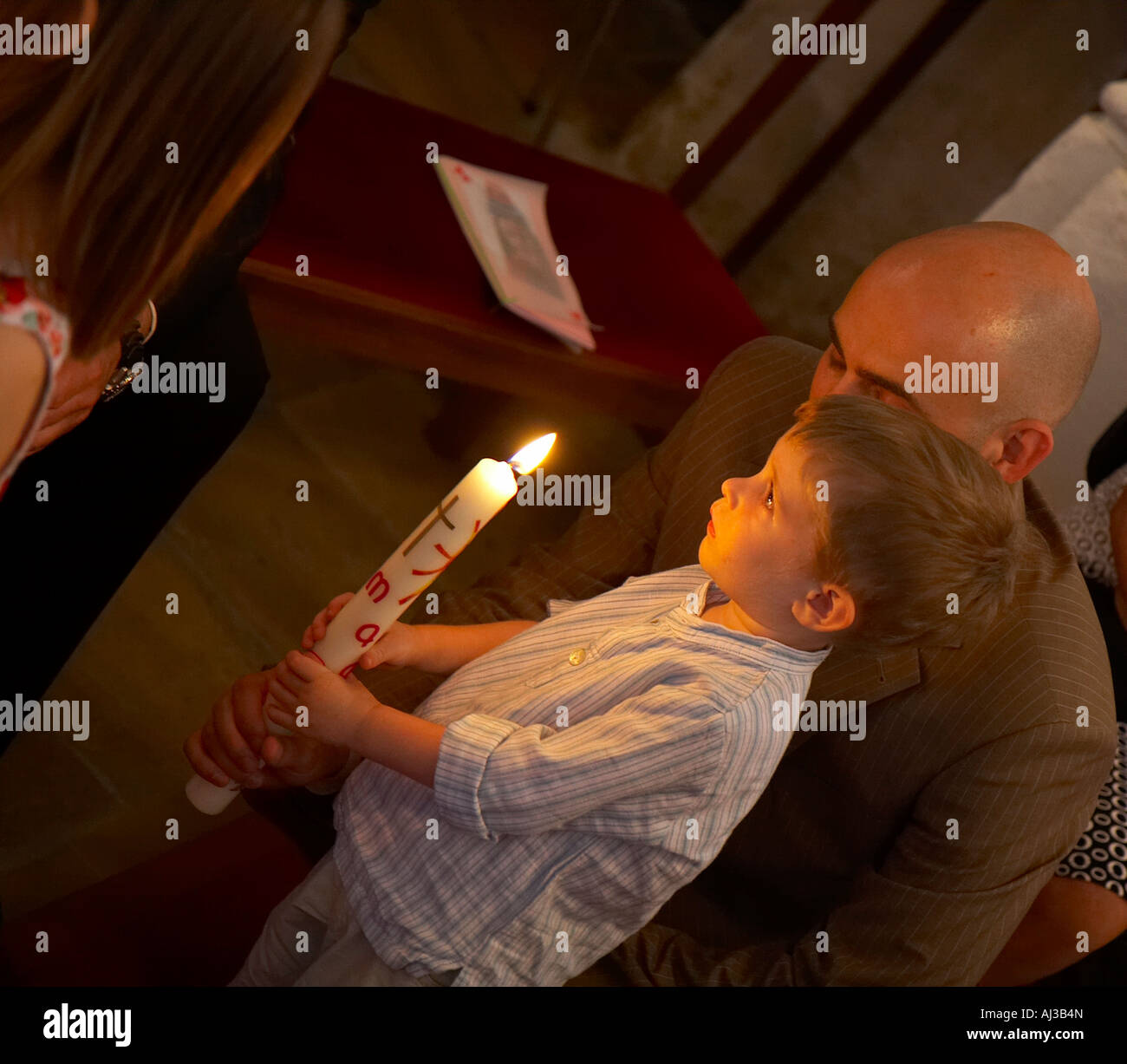 little boy with baptism candle Stock Photo Alamy