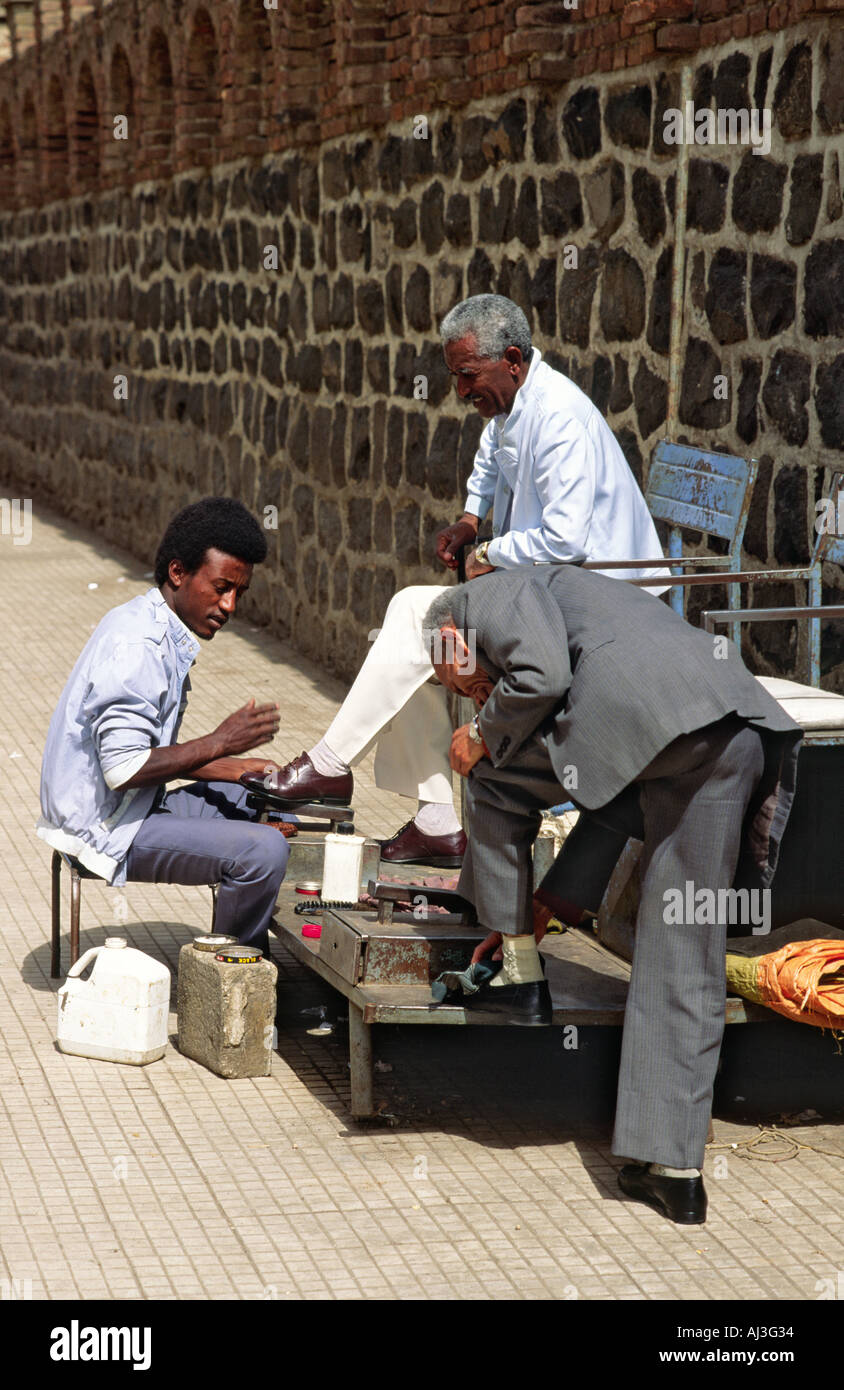 A shoe polisher doing good business on a street in Asmara. A love of good shoes is a legacy left by the country's Italian colonialists. Eritrea, Stock Photo