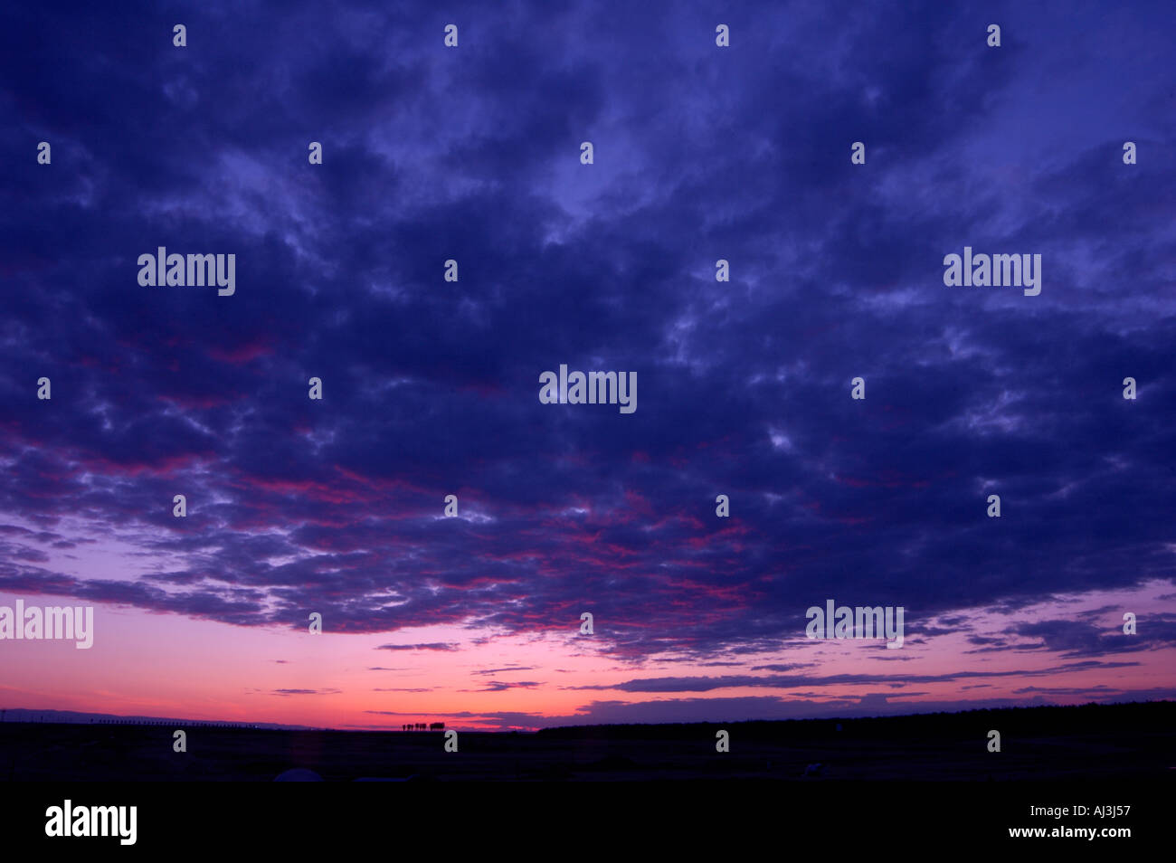 Dark Stormy Clouds In Sky At Sunset Sunrise Stock Photo - Alamy