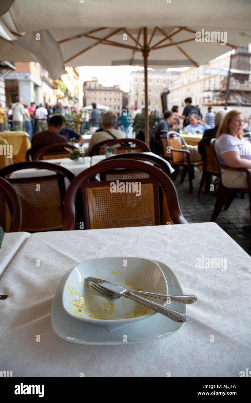 completely eaten bowl of Spaghetti Carbonara sitting on a table in a street cafe in the Piazza Navona Rome Lazio Italy Stock Photo