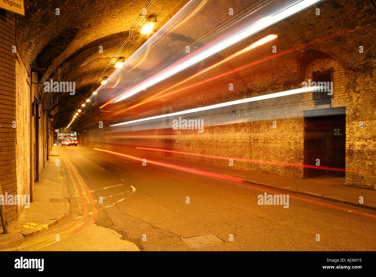 Car tunnel at night in central London with car tail lights streaking