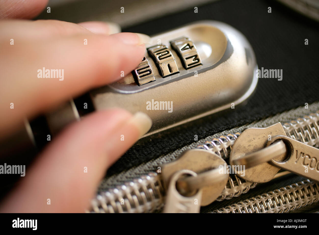 Setting security lock on luggage Stock Photo Alamy