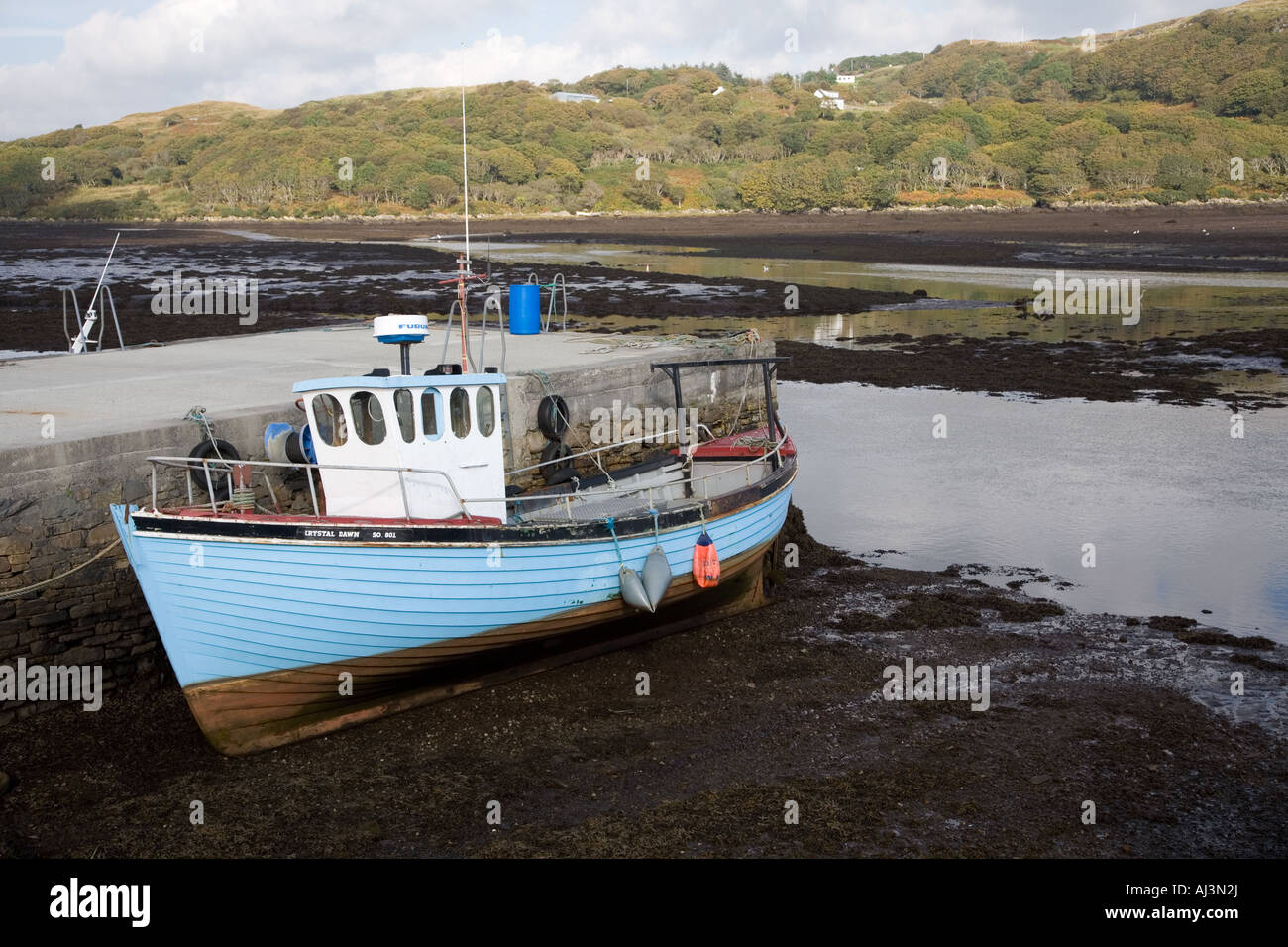 Stock photo of small boat grounded in low tide Shot in Teelin Bay County Donegal Ireland in October 2007 Stock Photo