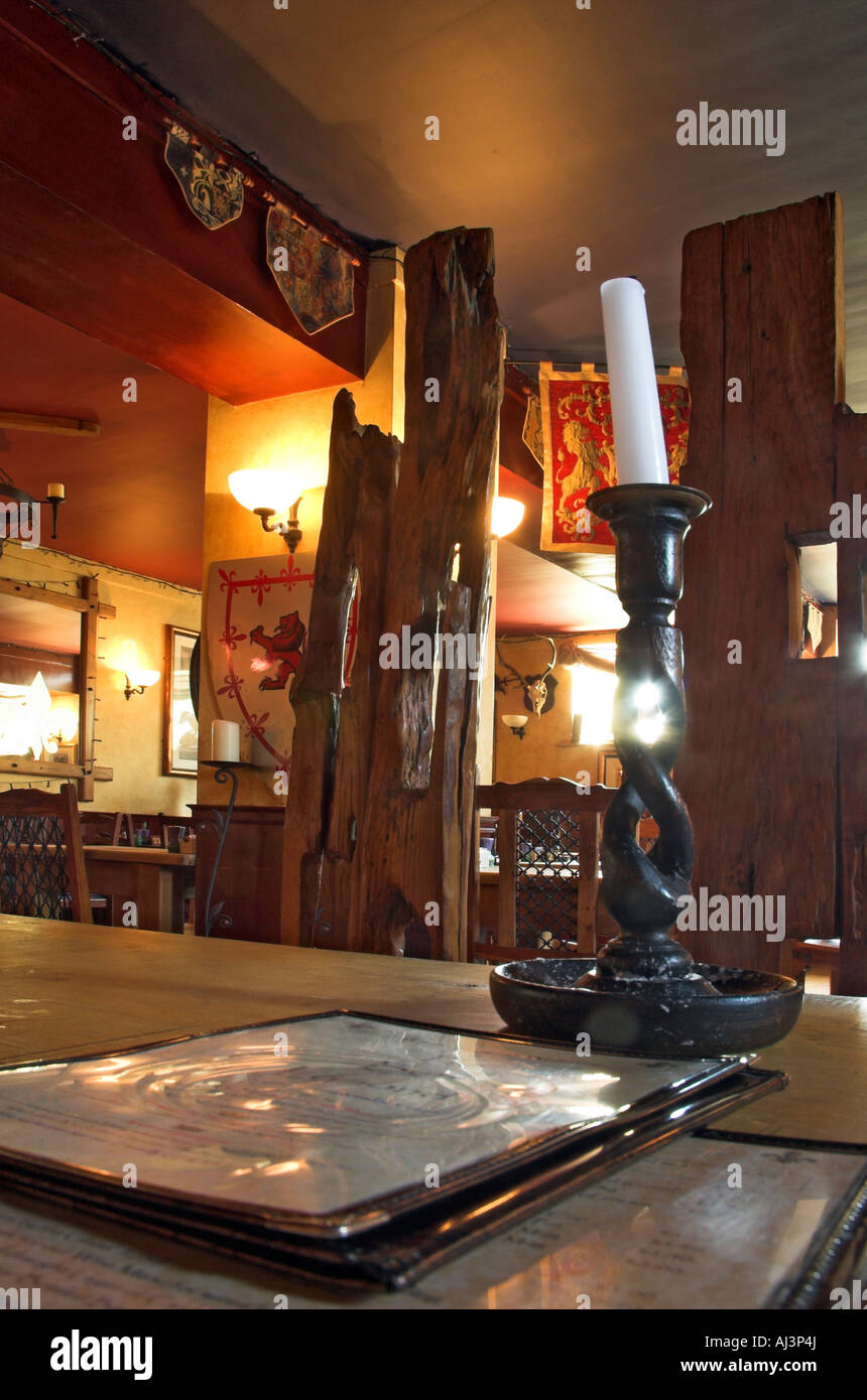 A menu and a candle on a table in a mediaeval restaurant Stock Photo