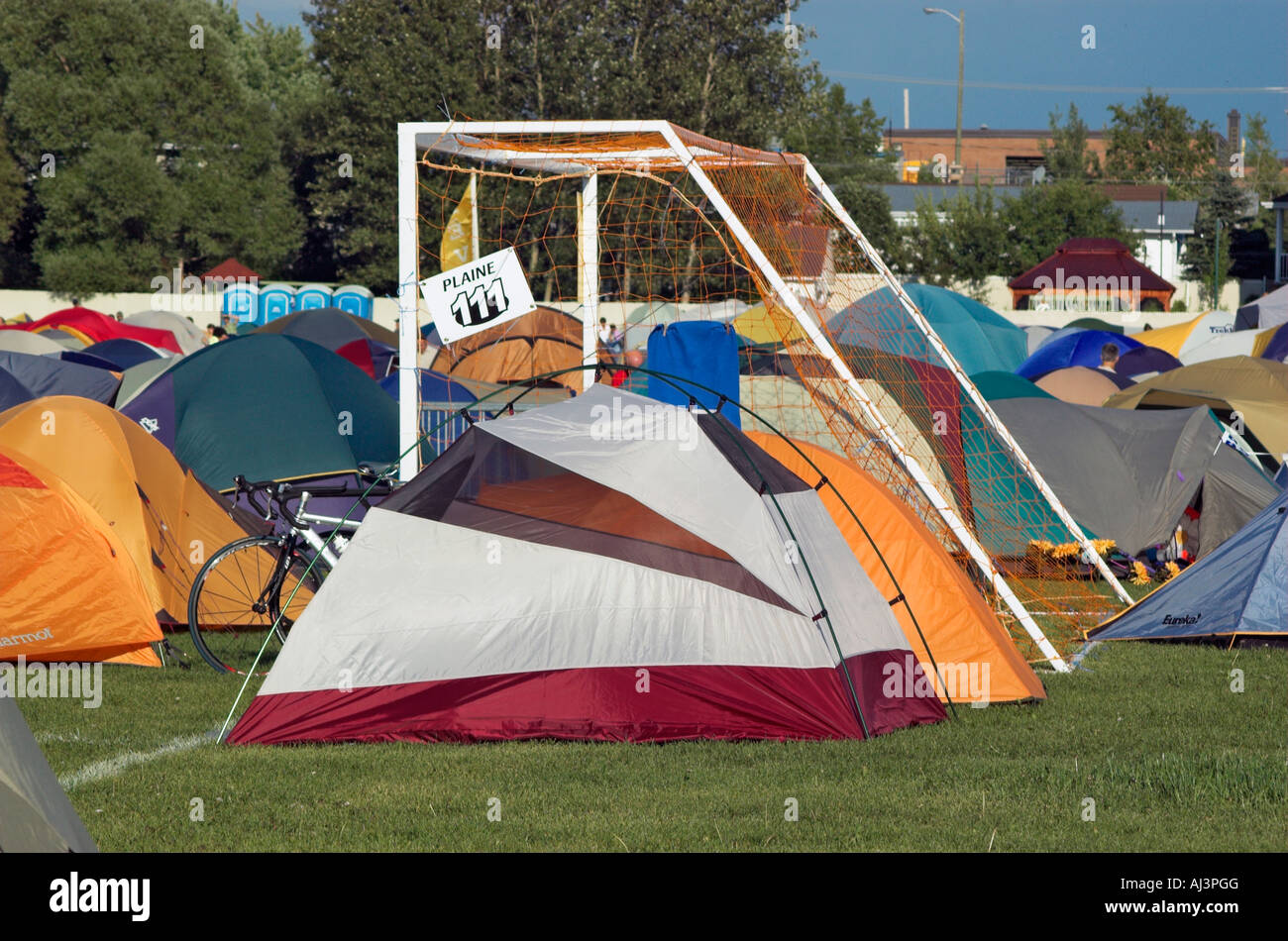 Hundreds of tents crammed together on a football pitch Stock Photo Alamy