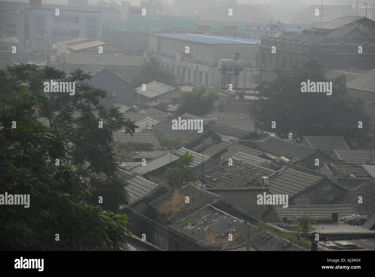 Old Houses in Beijing covered with pollution bad air smoke Stock Photo