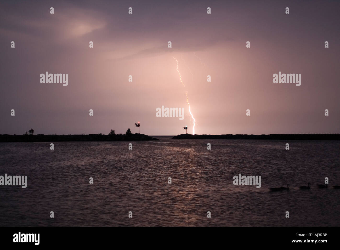 Dramatic Lightning Strike Over Tranquil Waters at Dusk Stock Photo - Alamy