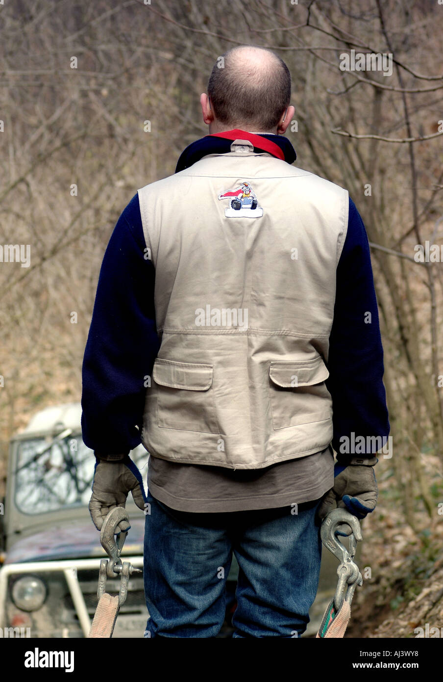 Winch operator co pilot with special adventure garment waits for Uaz