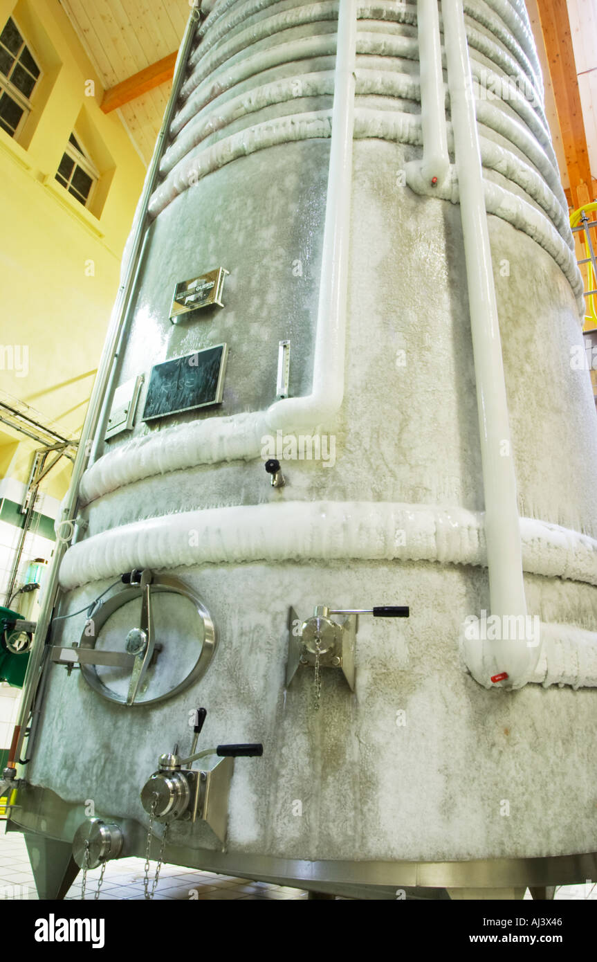 A stainless steel fermentation tank with still wine undergoing cold