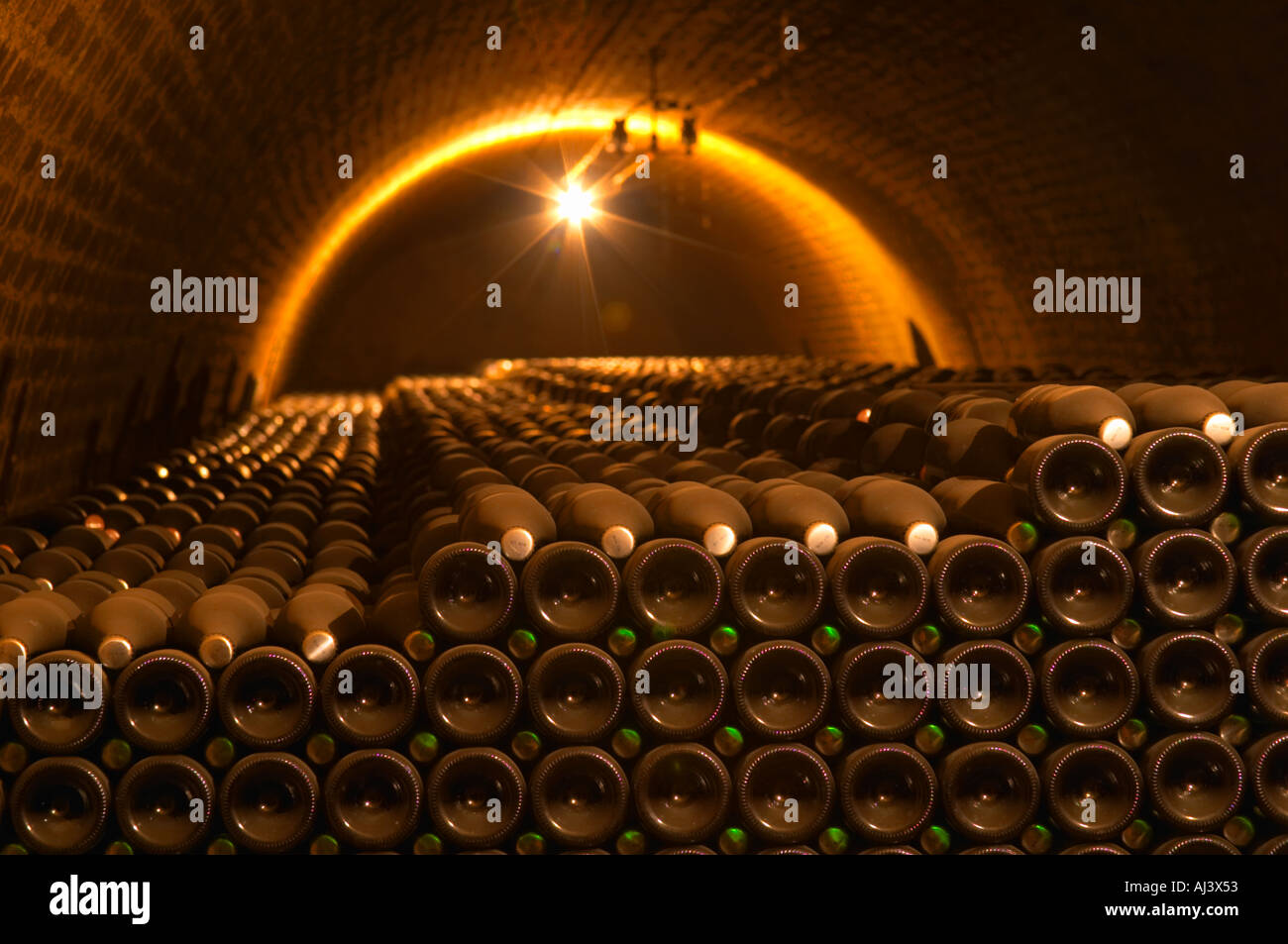 Champagne bottles stacked in an underground vaulted cellar closed with silver and green crown caps capsules in total 129956 bottles at Champagne Deutz in Ay, Vallee de la Marne, Champagne, Marne, Ardennes, France Stock Photo